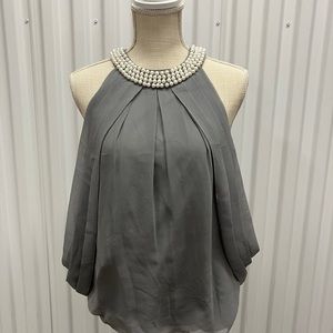 A beautiful sophisticated top sleeveless.